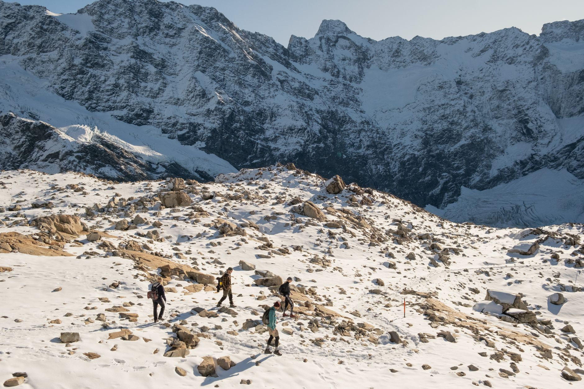 Hiker looking at majestic Southern Alps snow peaks